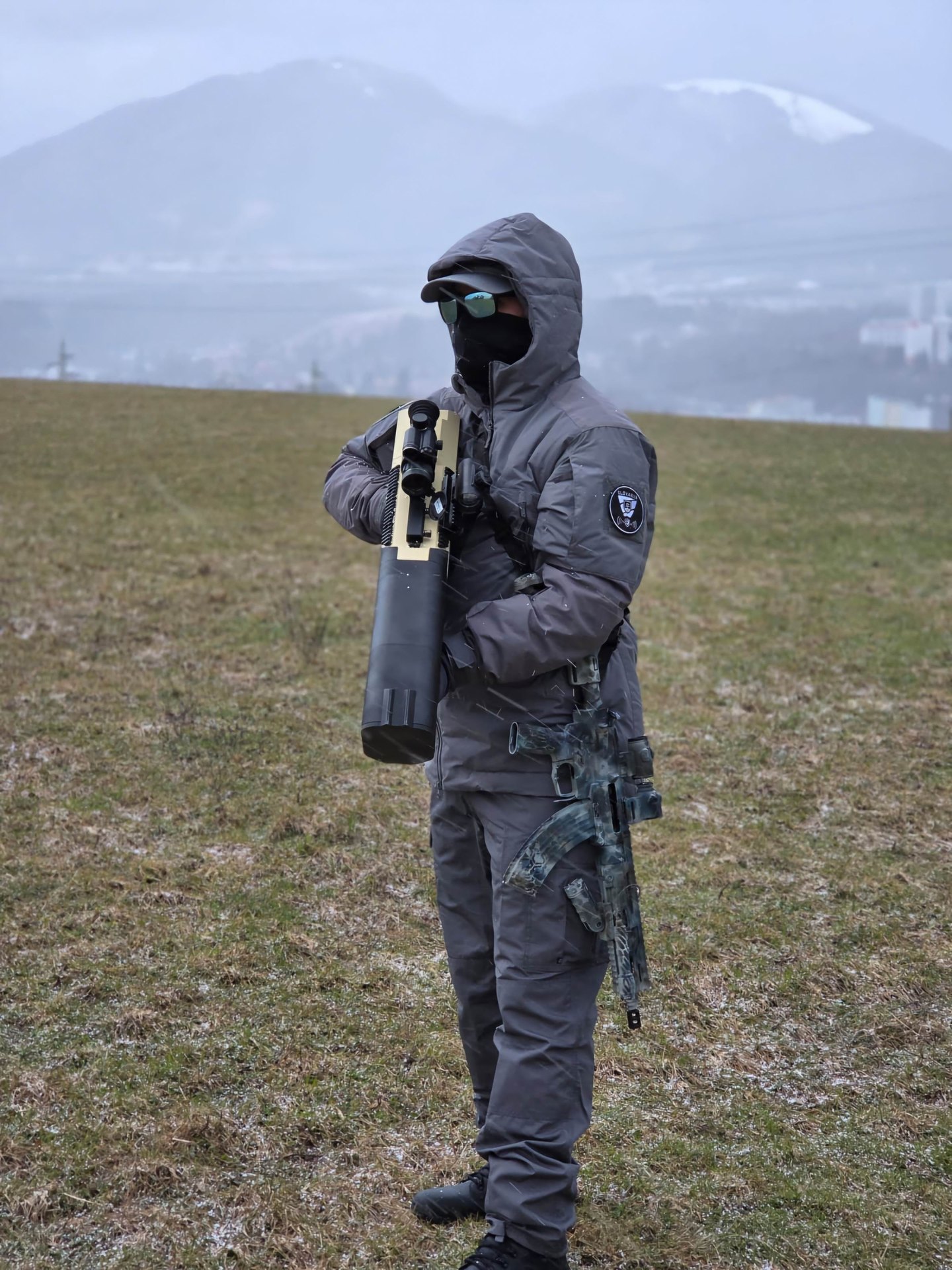 Operator carrying the ADP anti-drone rifle in open country